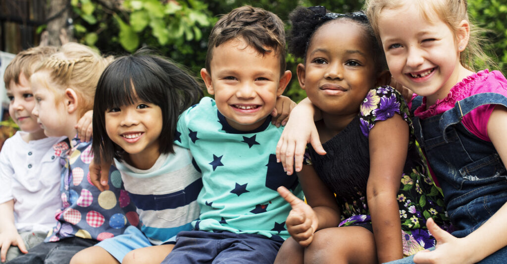 group of kids with their arms around eachother