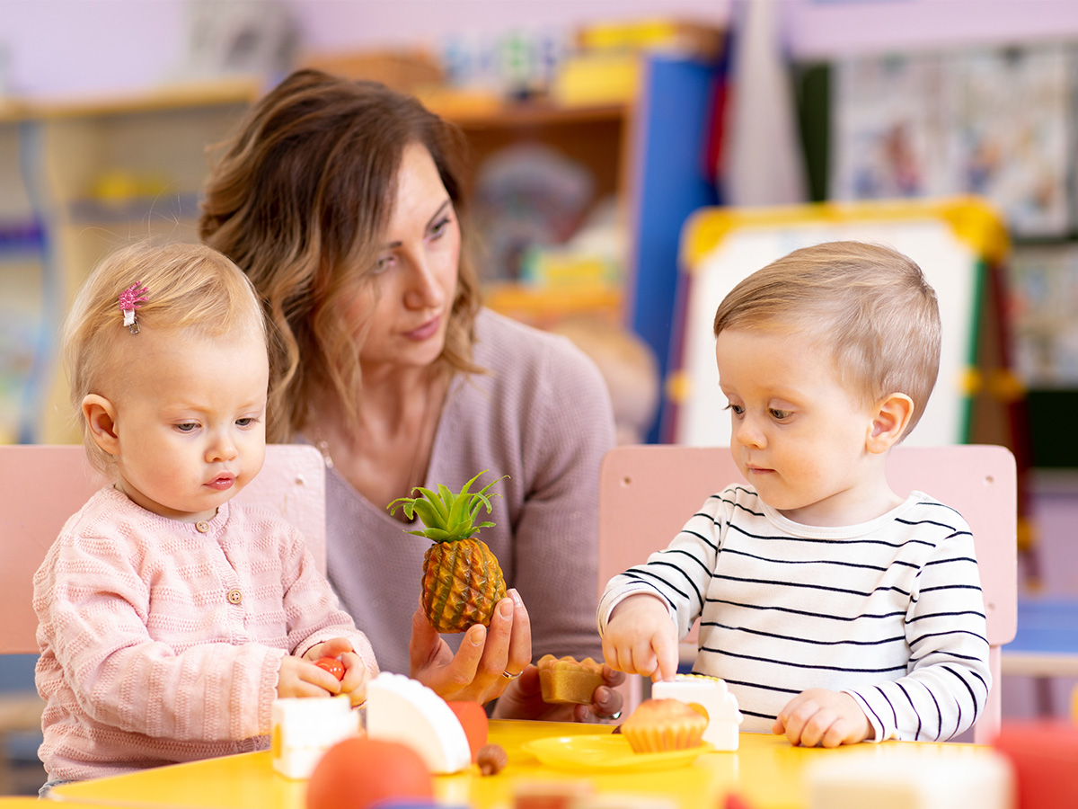 infants playing with toy food at daycare