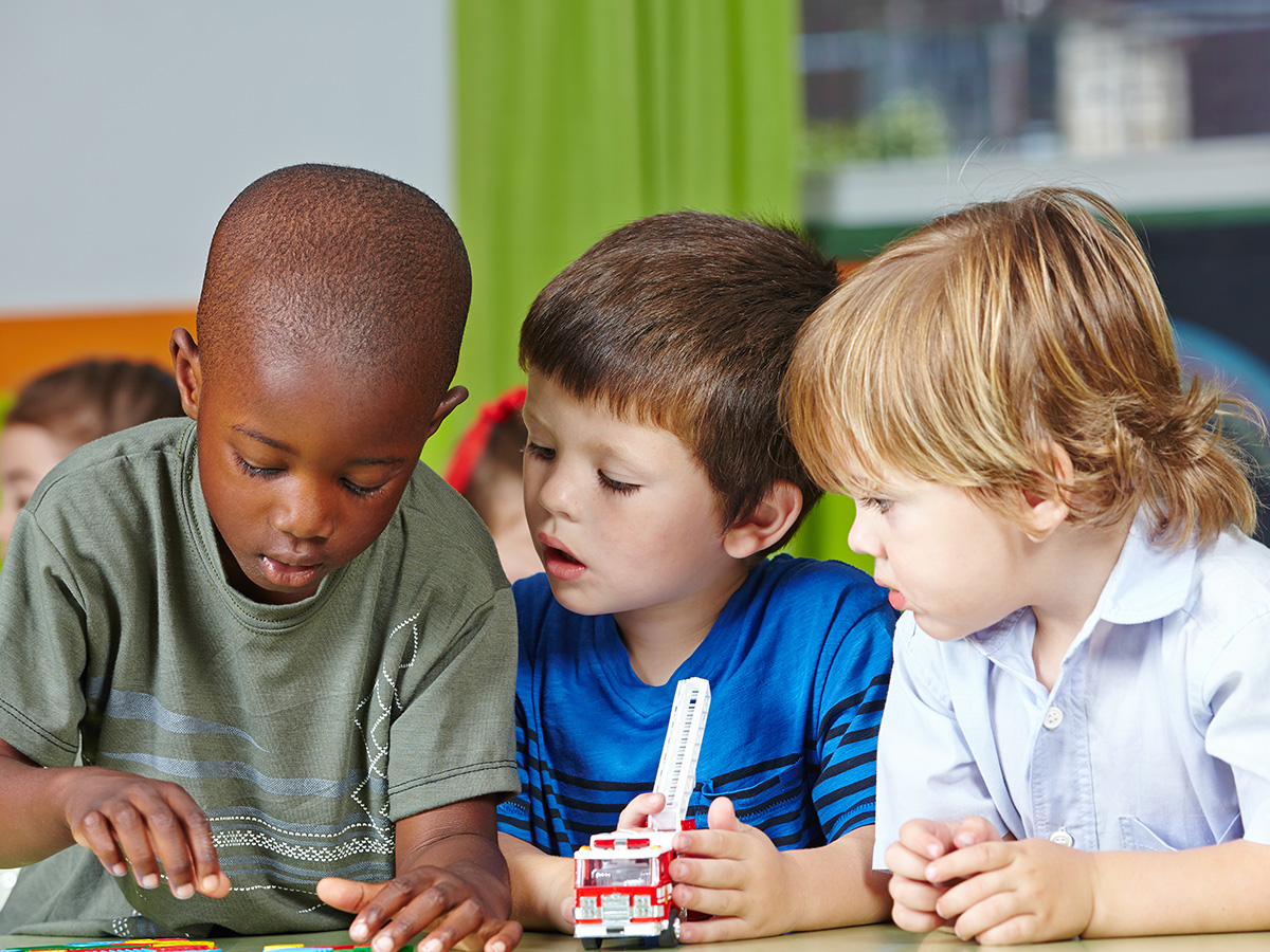 group of young boys playing with toys at daycare
