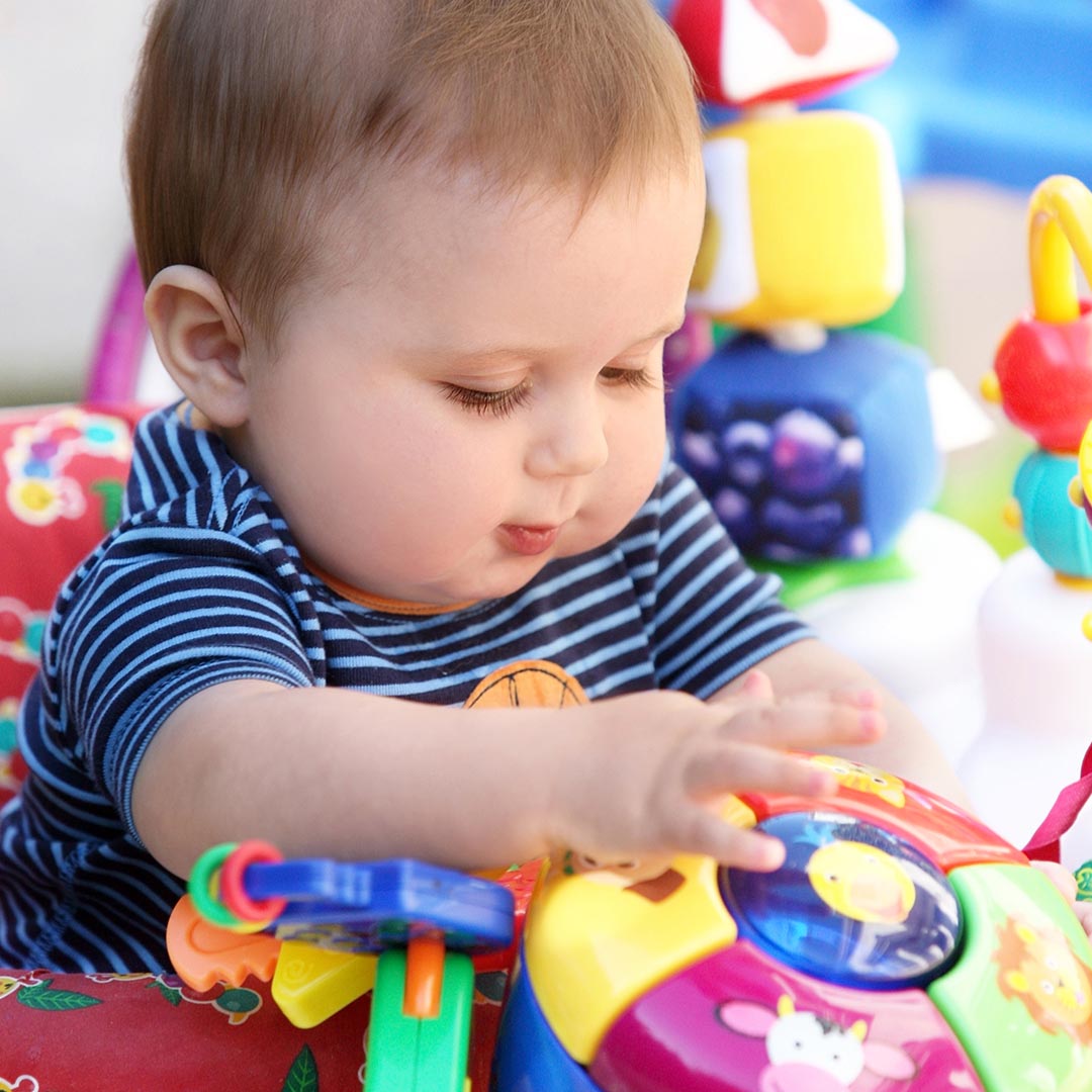 Infant playing with toys at daycare