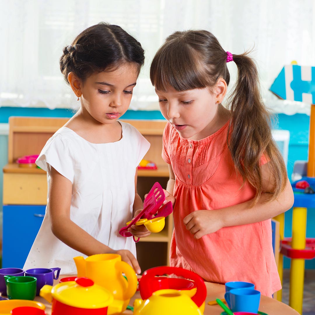 two girls playing with toys together