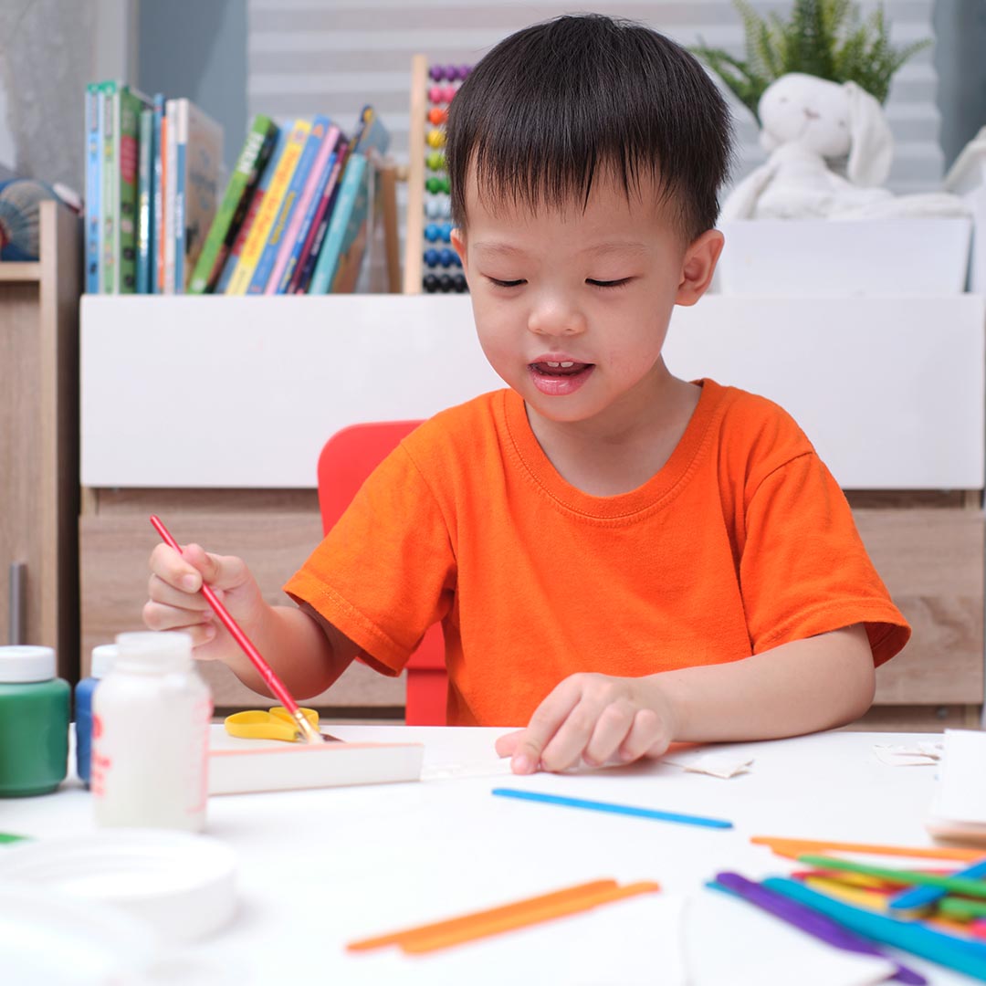 toddler painting at preschool