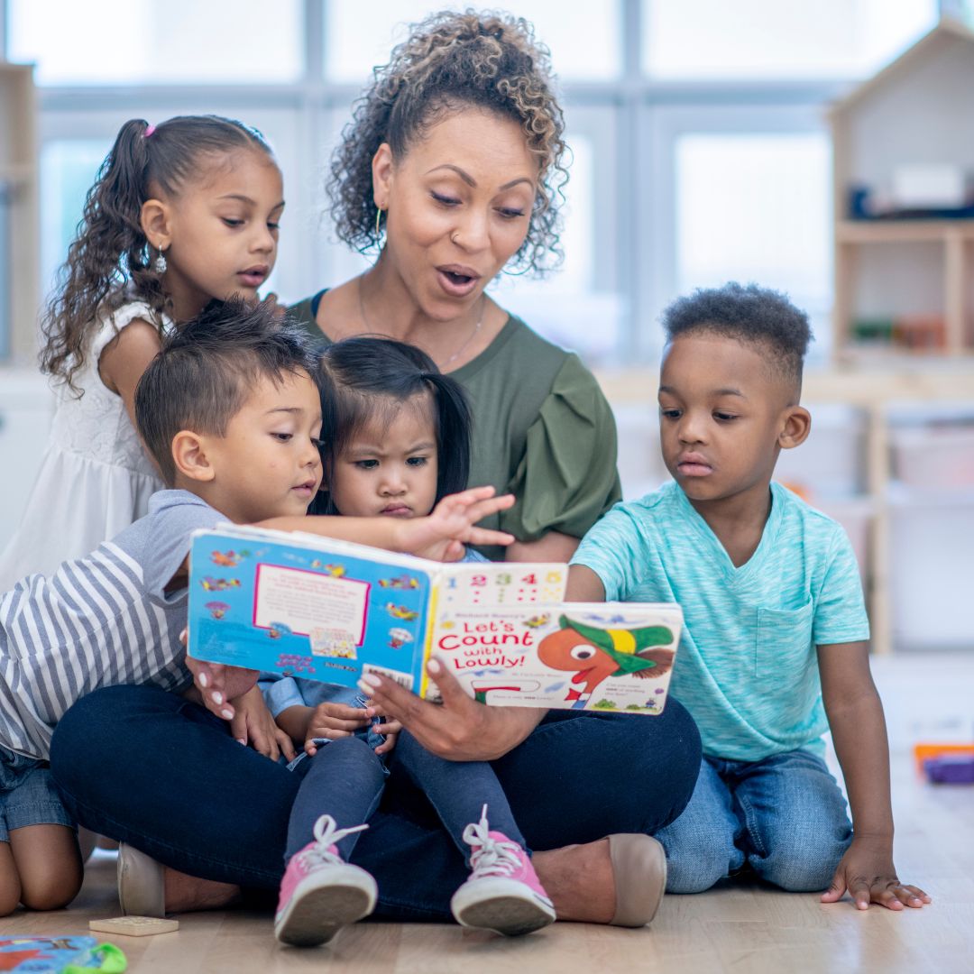 teacher reading to young kids