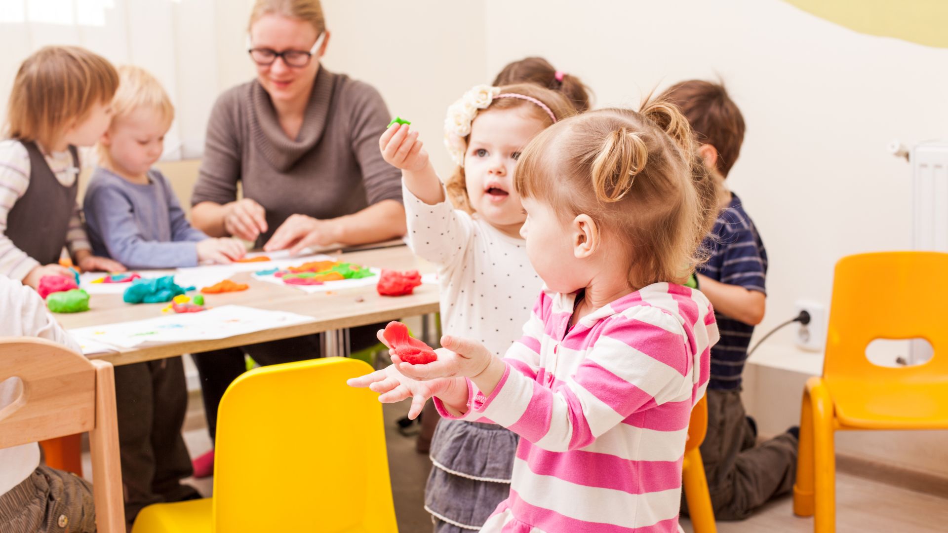 Daycare kids at table playing with Play-Doh