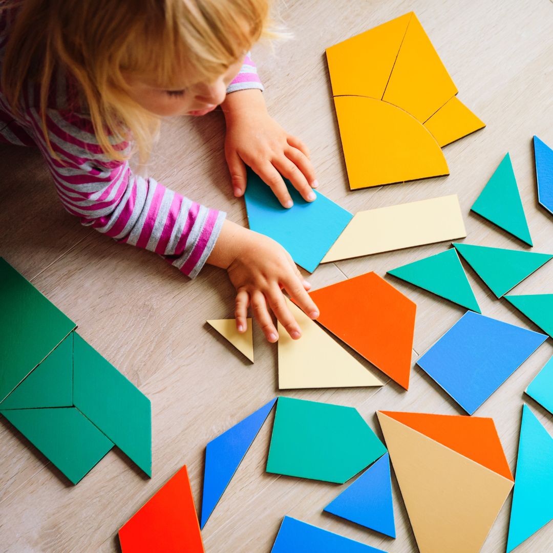 a girl playing with colored shapes