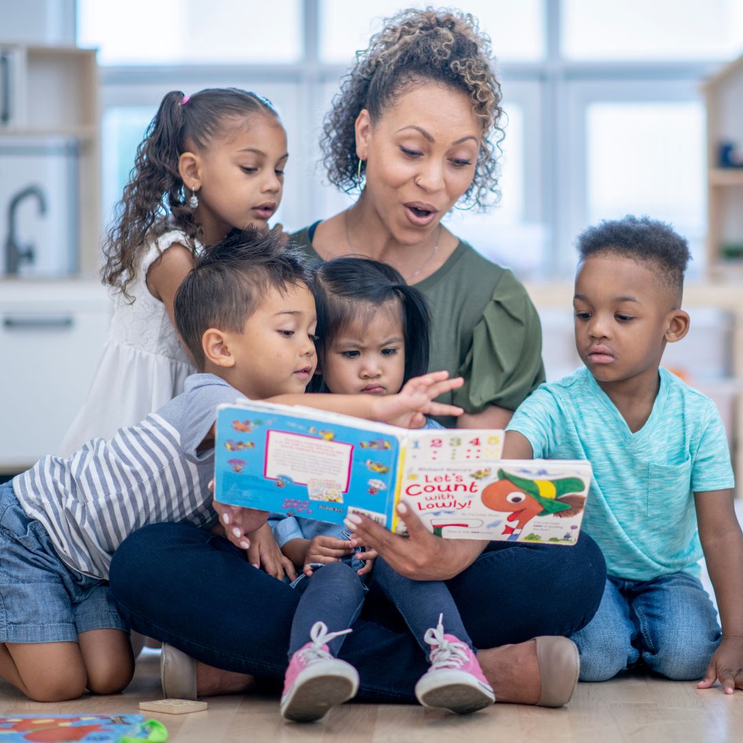 a teacher reading to her daycare kids
