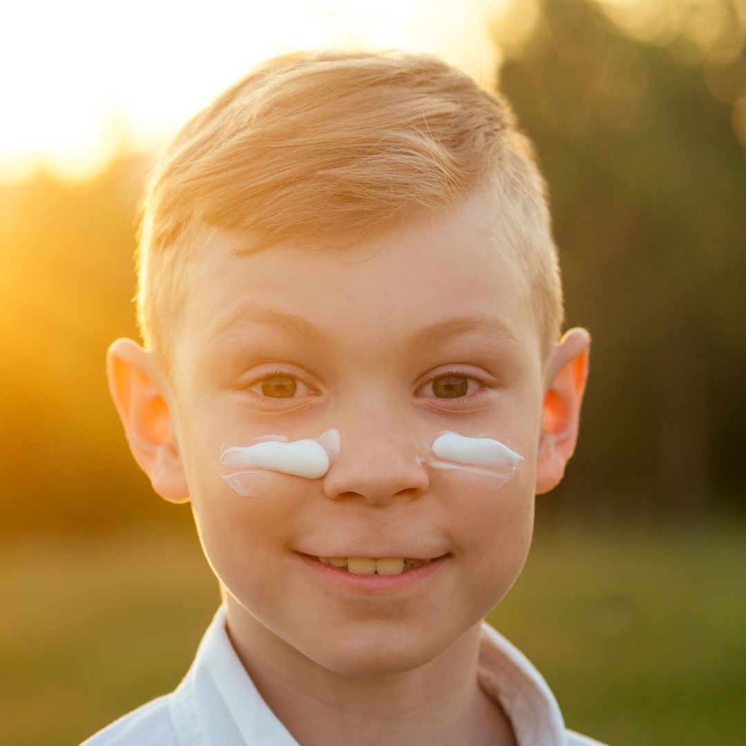Young boy with sunscreen on his face.