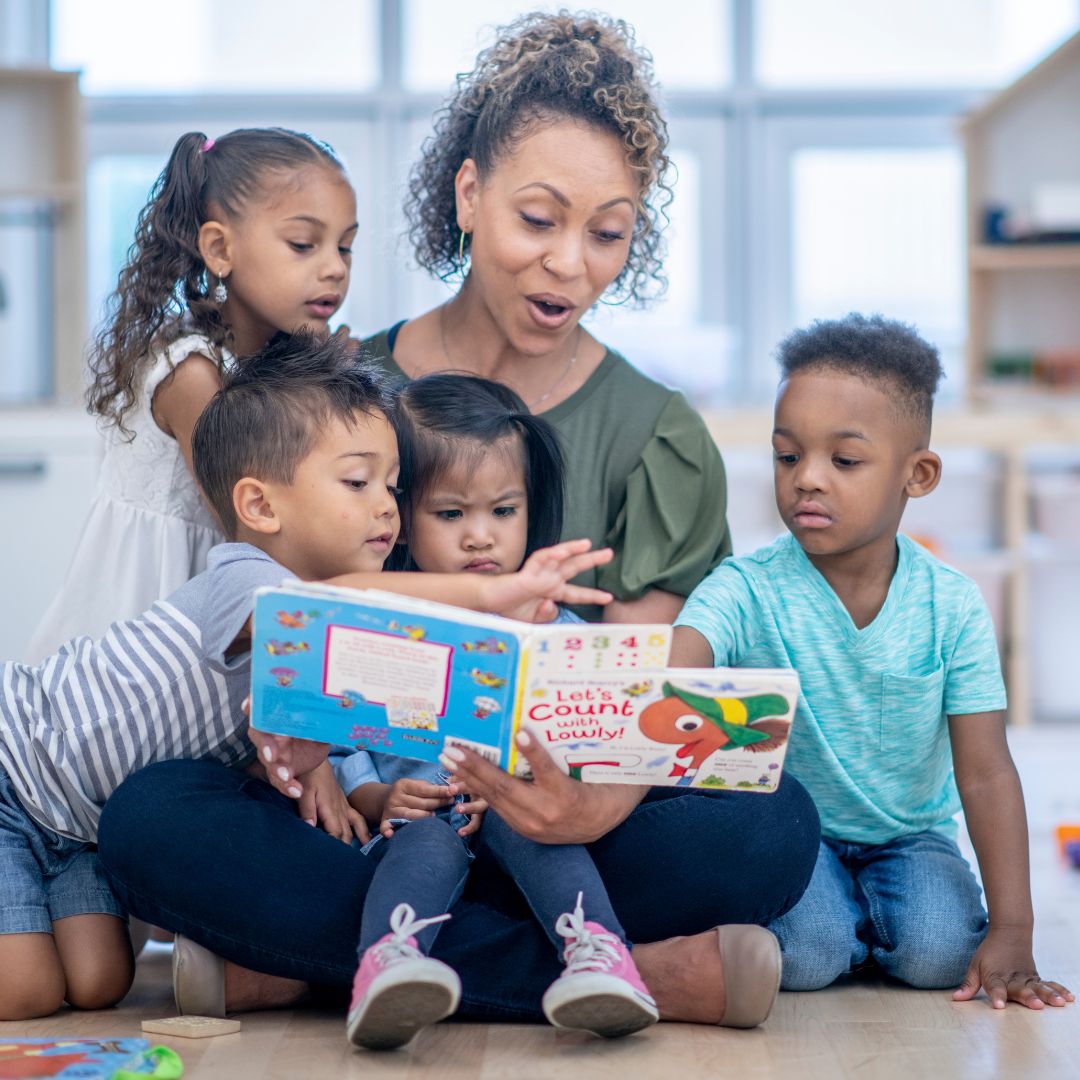 Teacher reading to daycare students.