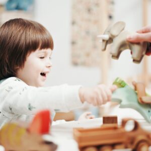 girl plays with animal toys