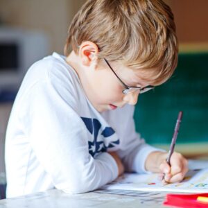 boy holding a pencil and doing school work